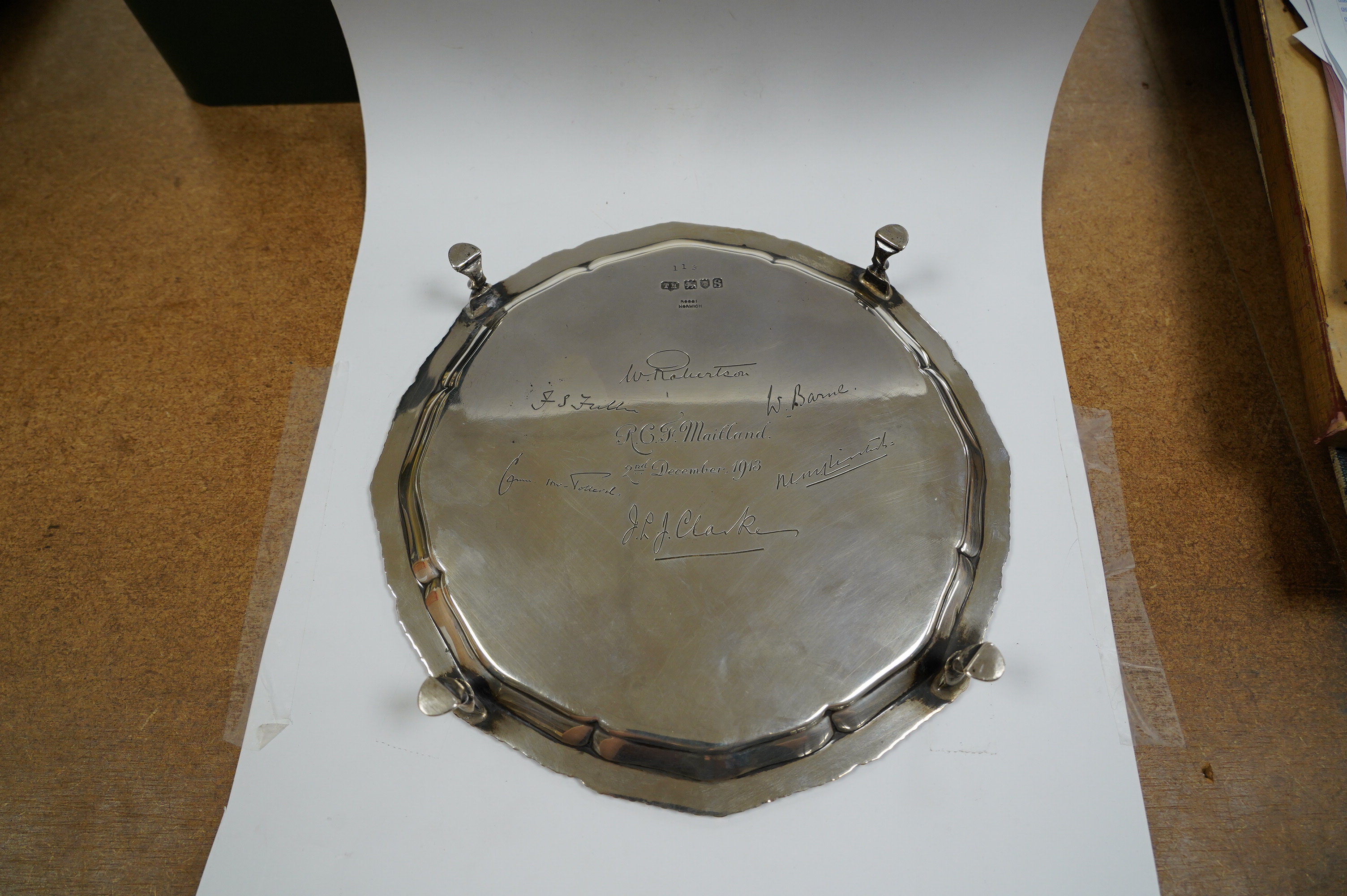 A George V silver shaped circular waiter, with engraved signatures, by Theodore Rossi, London, 1913, on four hoof feet, 203cm, 13.6oz. Condition - fair